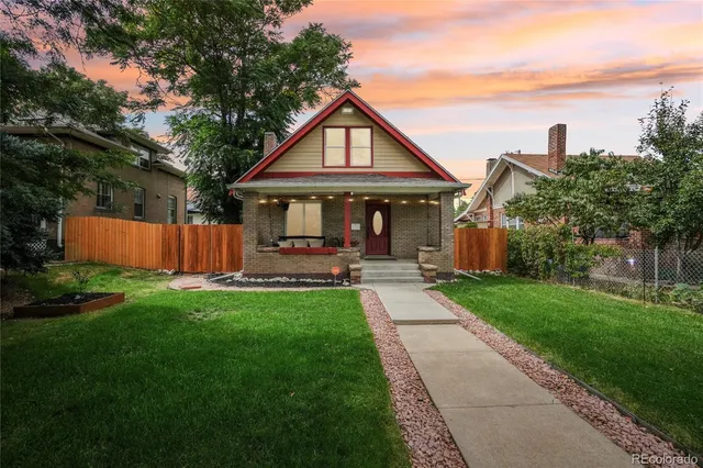 a front view of a house with yard and green space