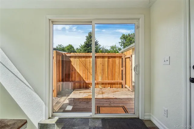 a view of a balcony with wooden floor and a potted plant