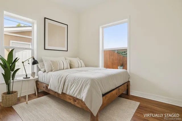 a bedroom with a large bed and potted plant