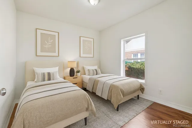 a bedroom with two beds and a window