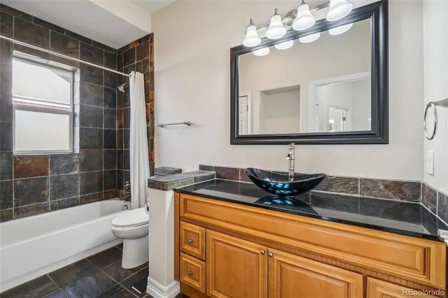 a bathroom with a sink a toilet and bathtub