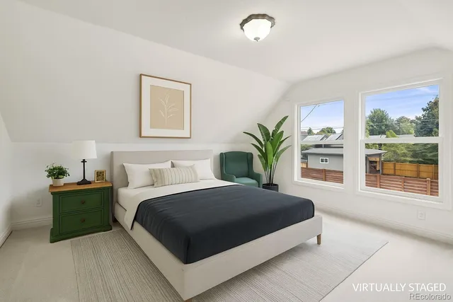 a bedroom with a large bed and a large window