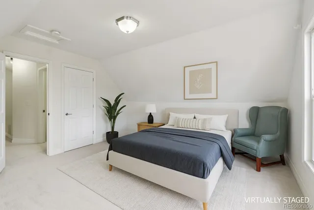 a bedroom with a bed and a couch