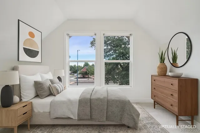 a bedroom with a bed and windows