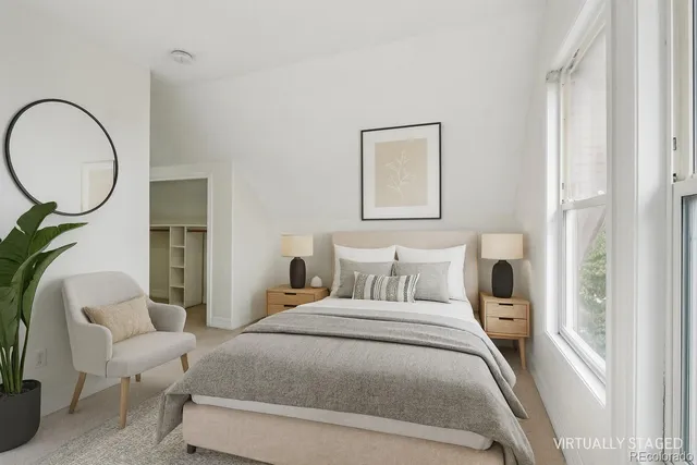 a bedroom with a bed a mirror and a window