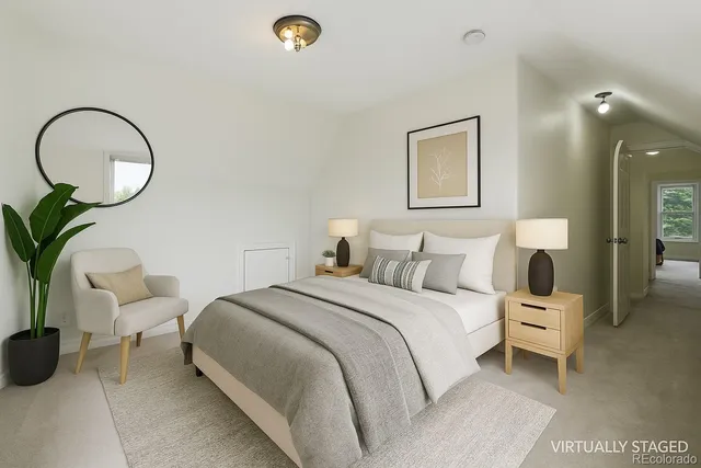 a bedroom with bed and a potted plant