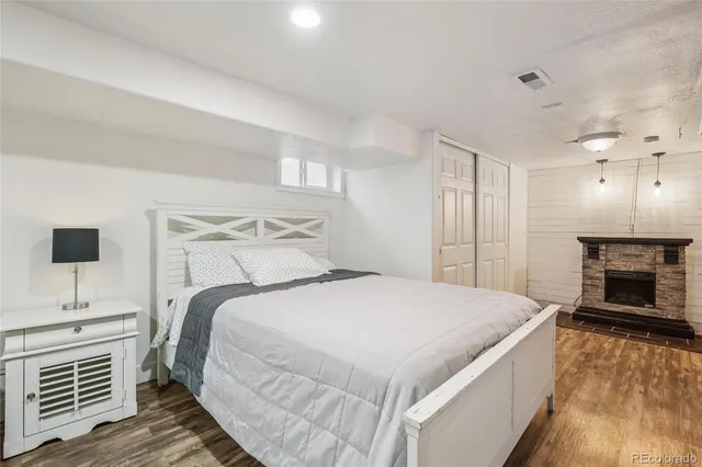 a bedroom with a bed and a fireplace