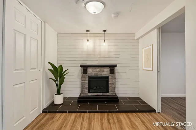 a living room with a fireplace and wooden floor