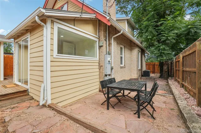 a view of a house with backyard and sitting area