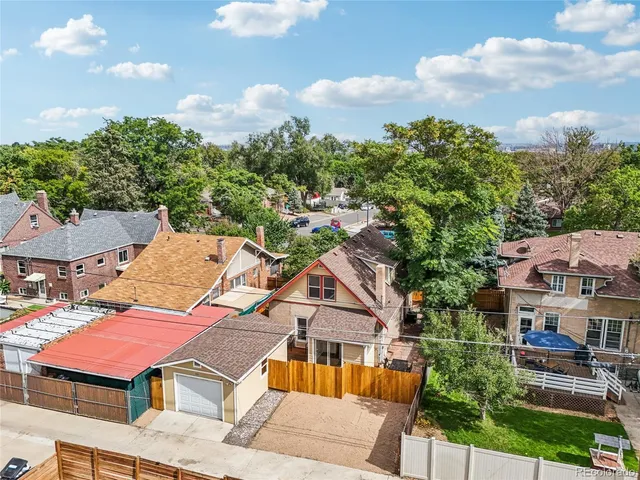 an aerial view of multiple houses with yard