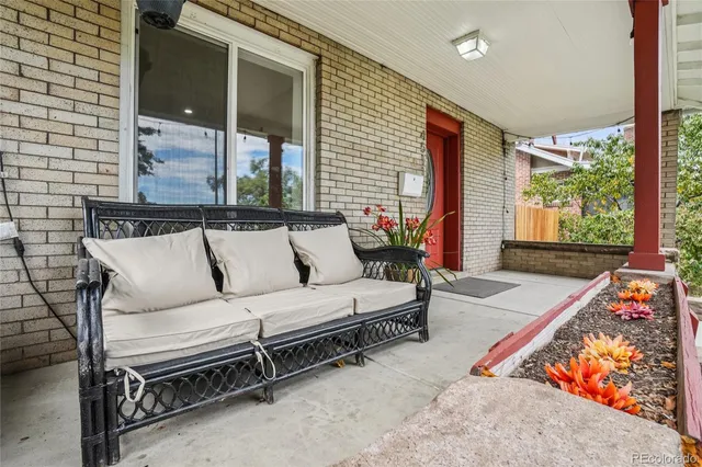 a living room with furniture a rug and a large window
