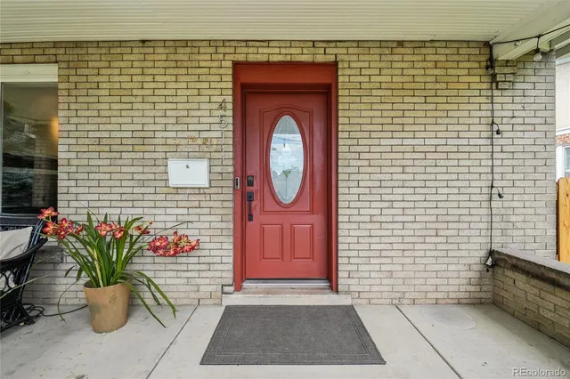 a front view of a house with potted plants