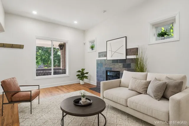 a living room with furniture fireplace and window