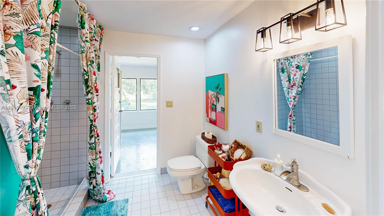 24545 Southwest 192nd Avenue Homestead, FL 33031 - Photo 28 of 91 a bathroom with a sink and a mirror
