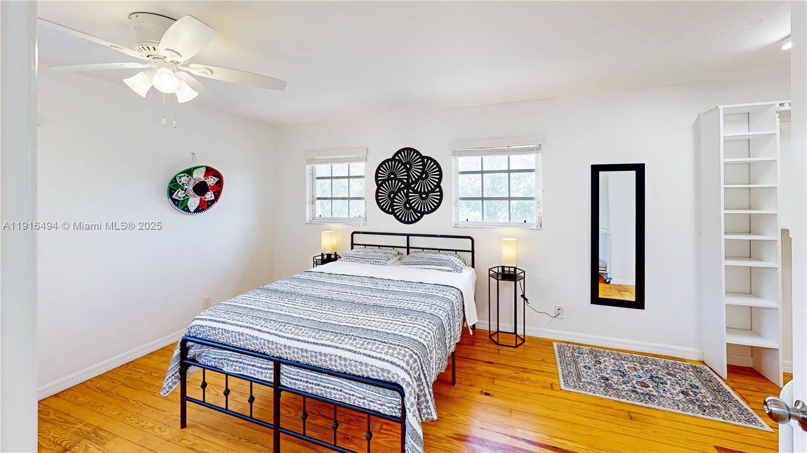 24545 Southwest 192nd Avenue Homestead, FL 33031 - Photo 55 of 91 a bedroom with a bed and a lamp on table