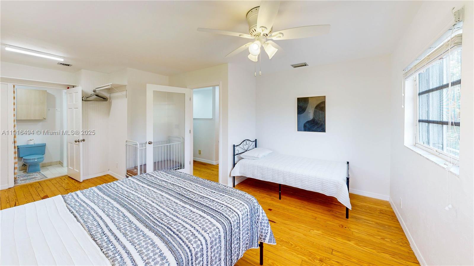 24545 Southwest 192nd Avenue Homestead, FL 33031 - Photo 57 of 91 a bedroom with a bed and a chandelier