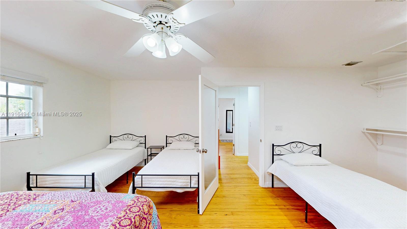 24545 Southwest 192nd Avenue Homestead, FL 33031 - Photo 63 of 91 a spacious bedroom with a bed and a chandelier