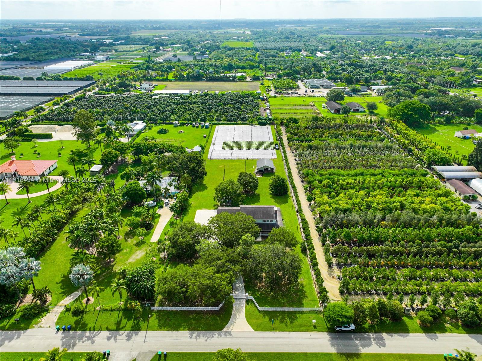 24545 Southwest 192nd Avenue Homestead, FL 33031 - Photo 88 of 91 an aerial view of residential houses with outdoor space and trees