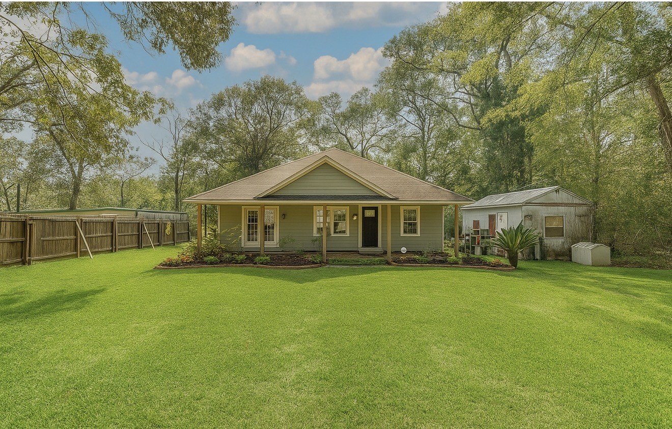 a front view of a house with yard and green space