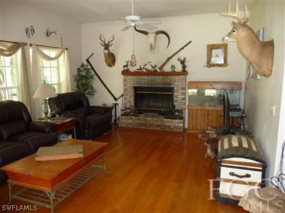21180 North River Road Alva, FL 33920 - Photo 5 of 10 a living room with furniture and a fireplace