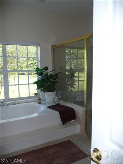 21180 North River Road Alva, FL 33920 - Photo 10 of 10 a bathroom with a tub and window