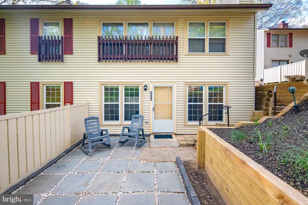 a view of a house with a wooden bench