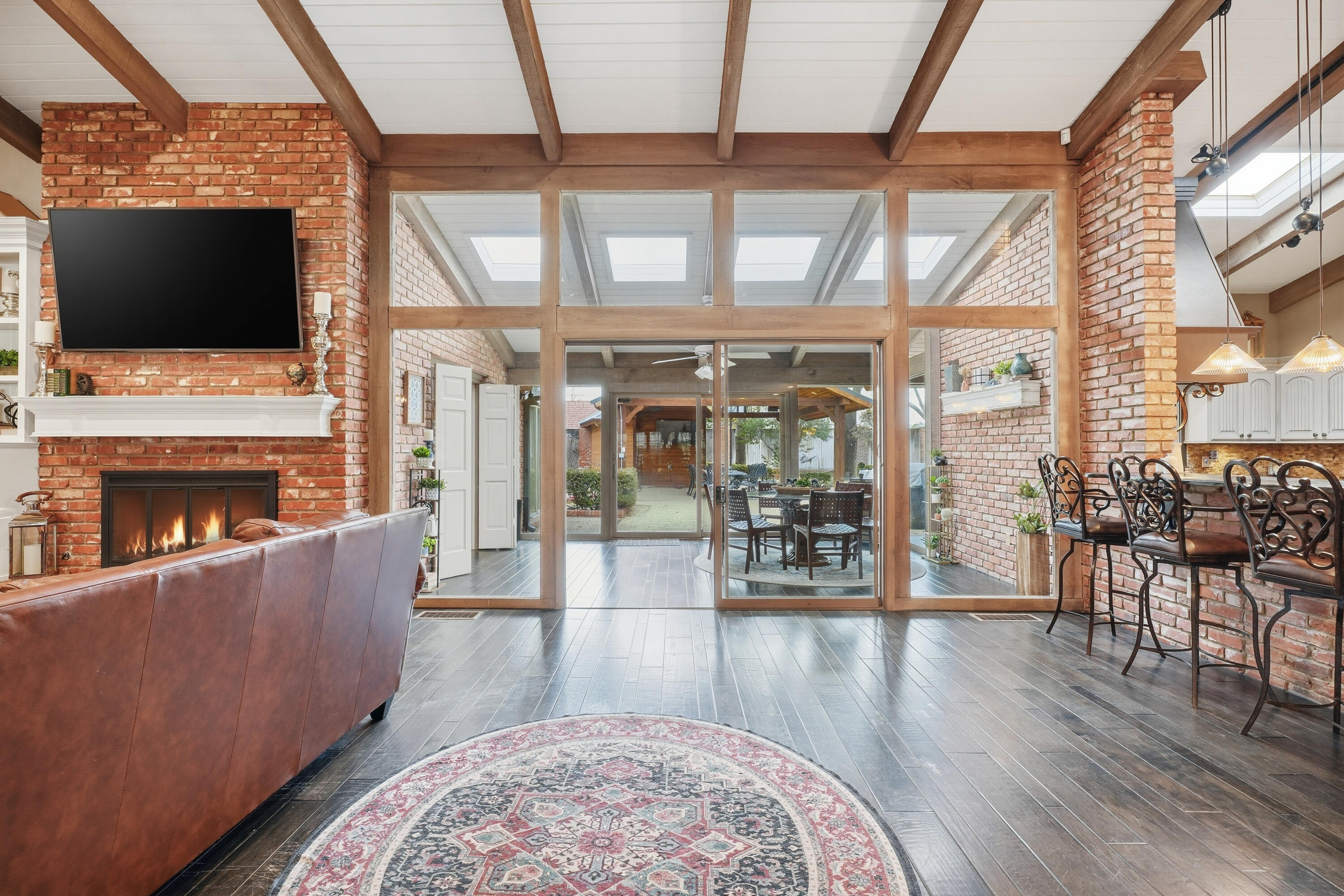 4602 13th Street Lubbock, TX 79416 - Photo 11 of 54 a living room with furniture a flat screen tv and a fireplace