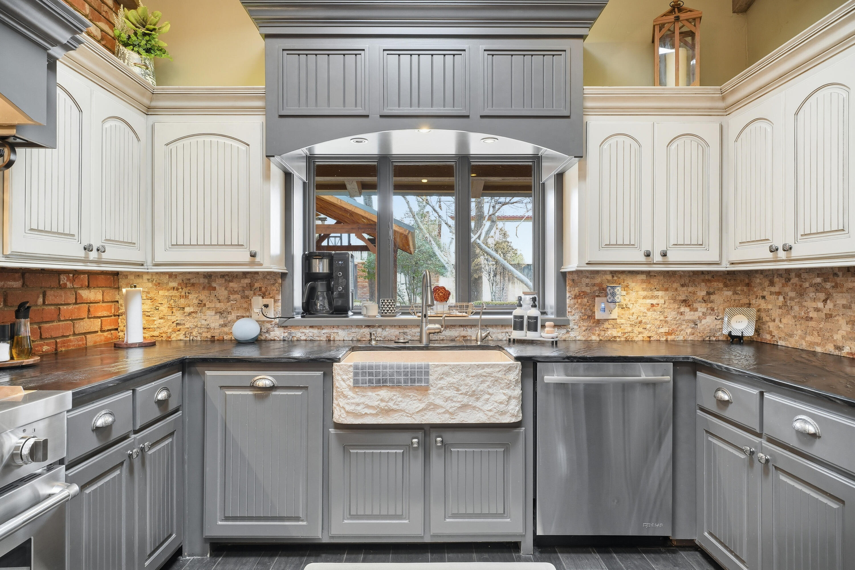 4602 13th Street Lubbock, TX 79416 - Photo 14 of 54 a kitchen with granite countertop a sink and cabinets
