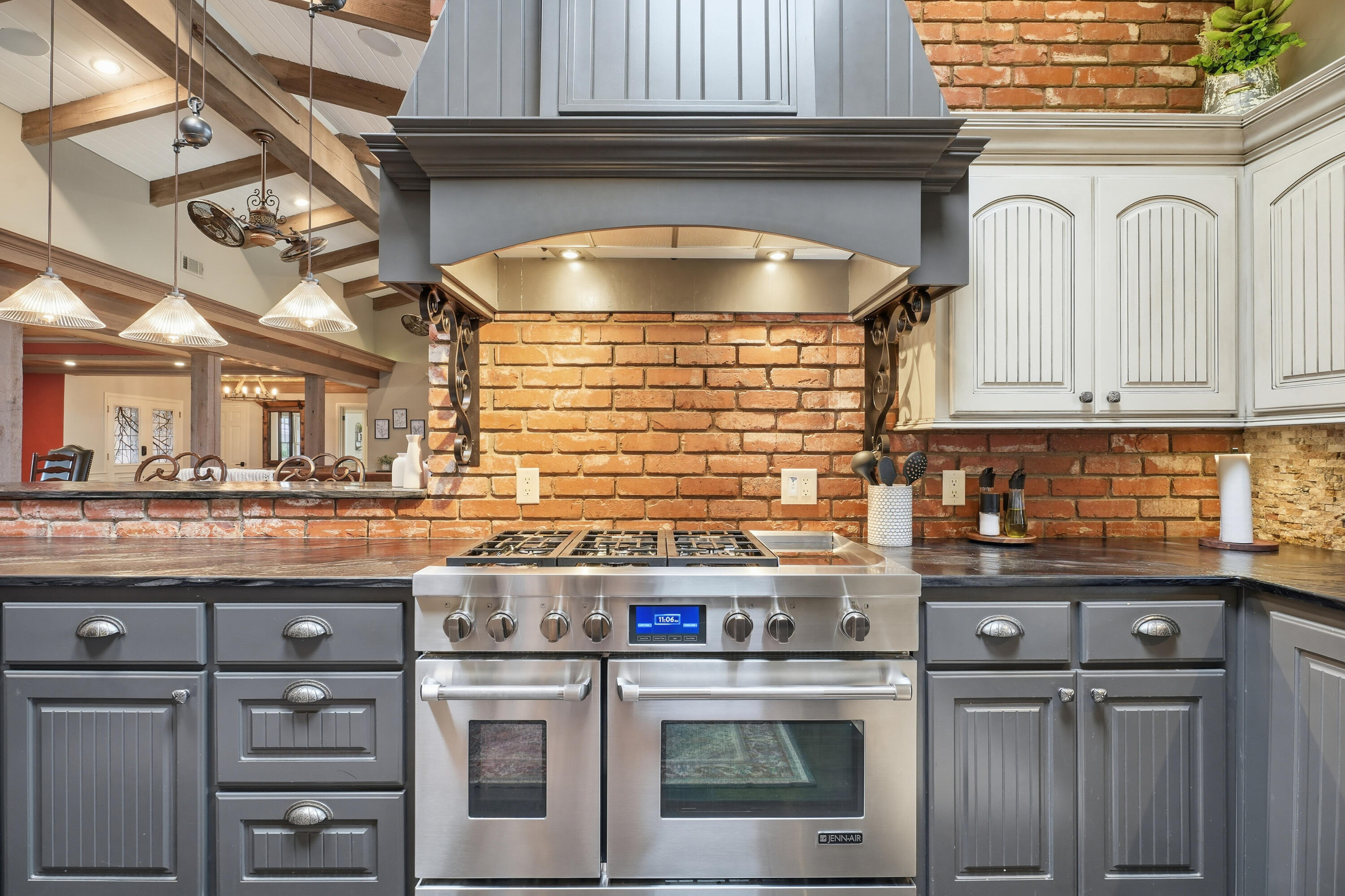 4602 13th Street Lubbock, TX 79416 - Photo 15 of 54 a kitchen with kitchen island a stove a sink and cabinets