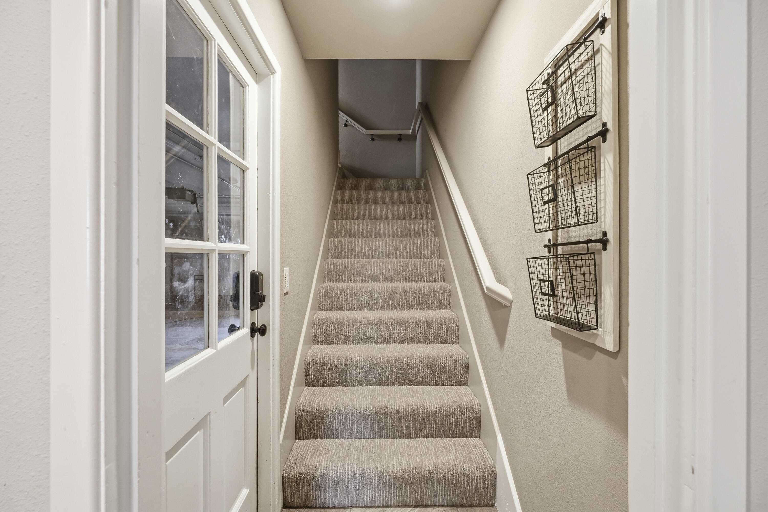 4602 13th Street Lubbock, TX 79416 - Photo 22 of 54 a view of staircase with lots of frames on wall and a window