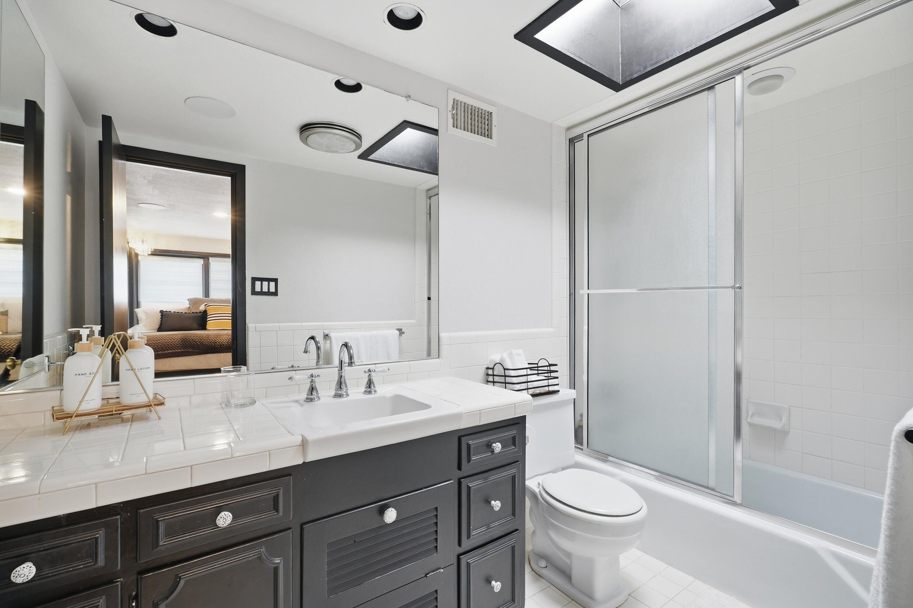 4602 13th Street Lubbock, TX 79416 - Photo 25 of 54 a bathroom with a double vanity sink toilet and shower