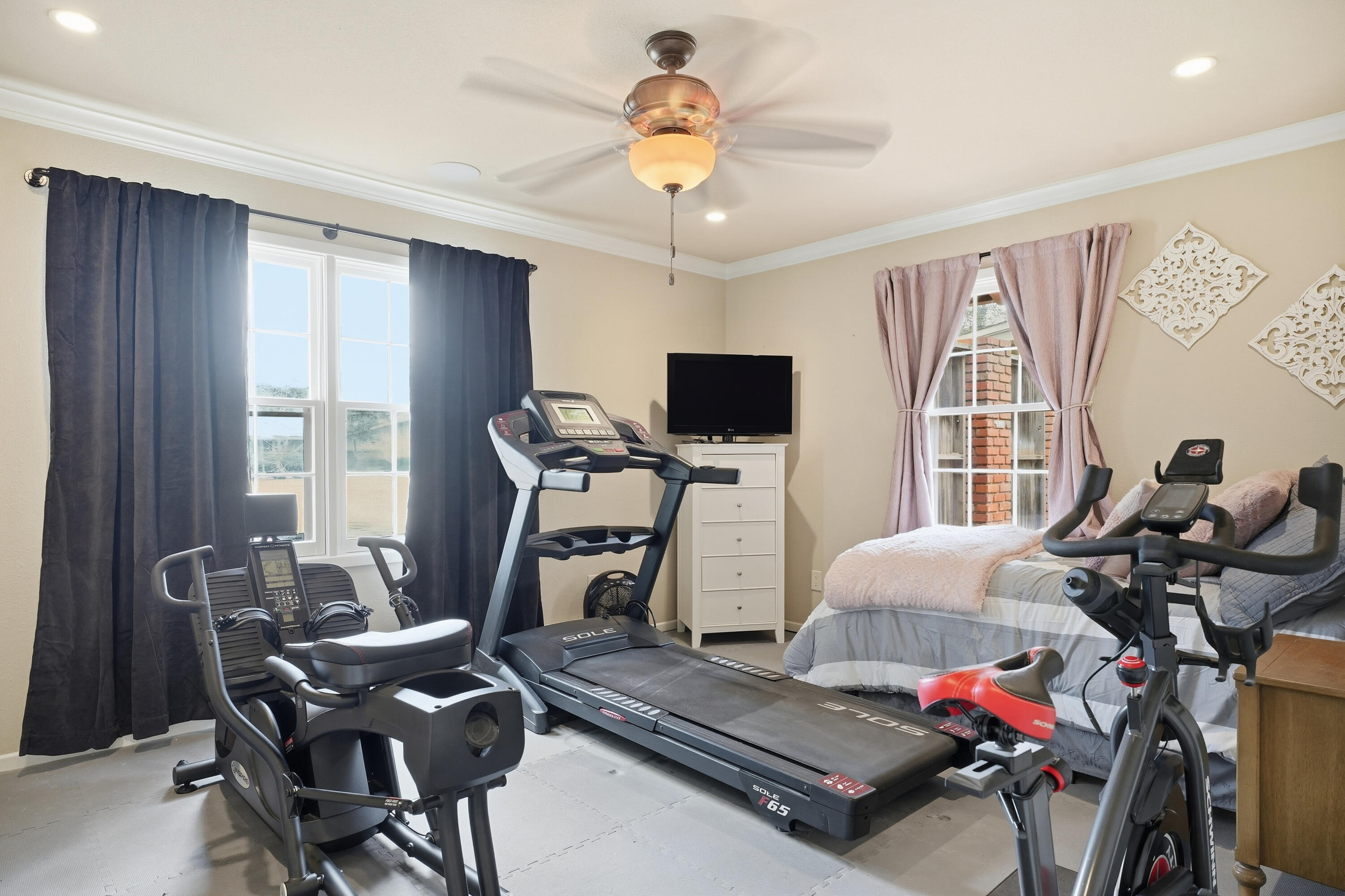 4602 13th Street Lubbock, TX 79416 - Photo 28 of 54 a living room with furniture a flat screen tv and a window