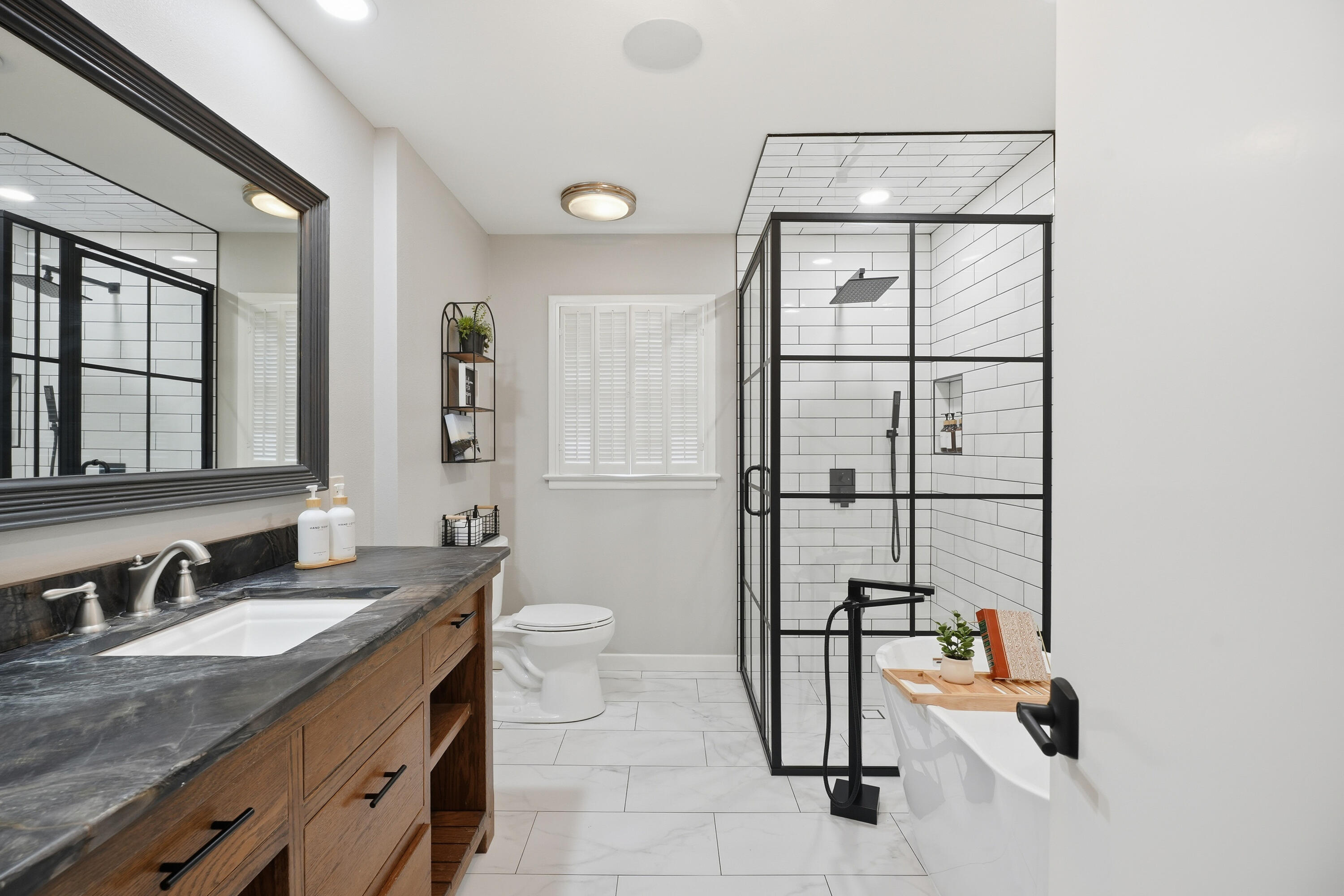 4602 13th Street Lubbock, TX 79416 - Photo 31 of 54 a bathroom with a granite countertop sink a toilet and shower