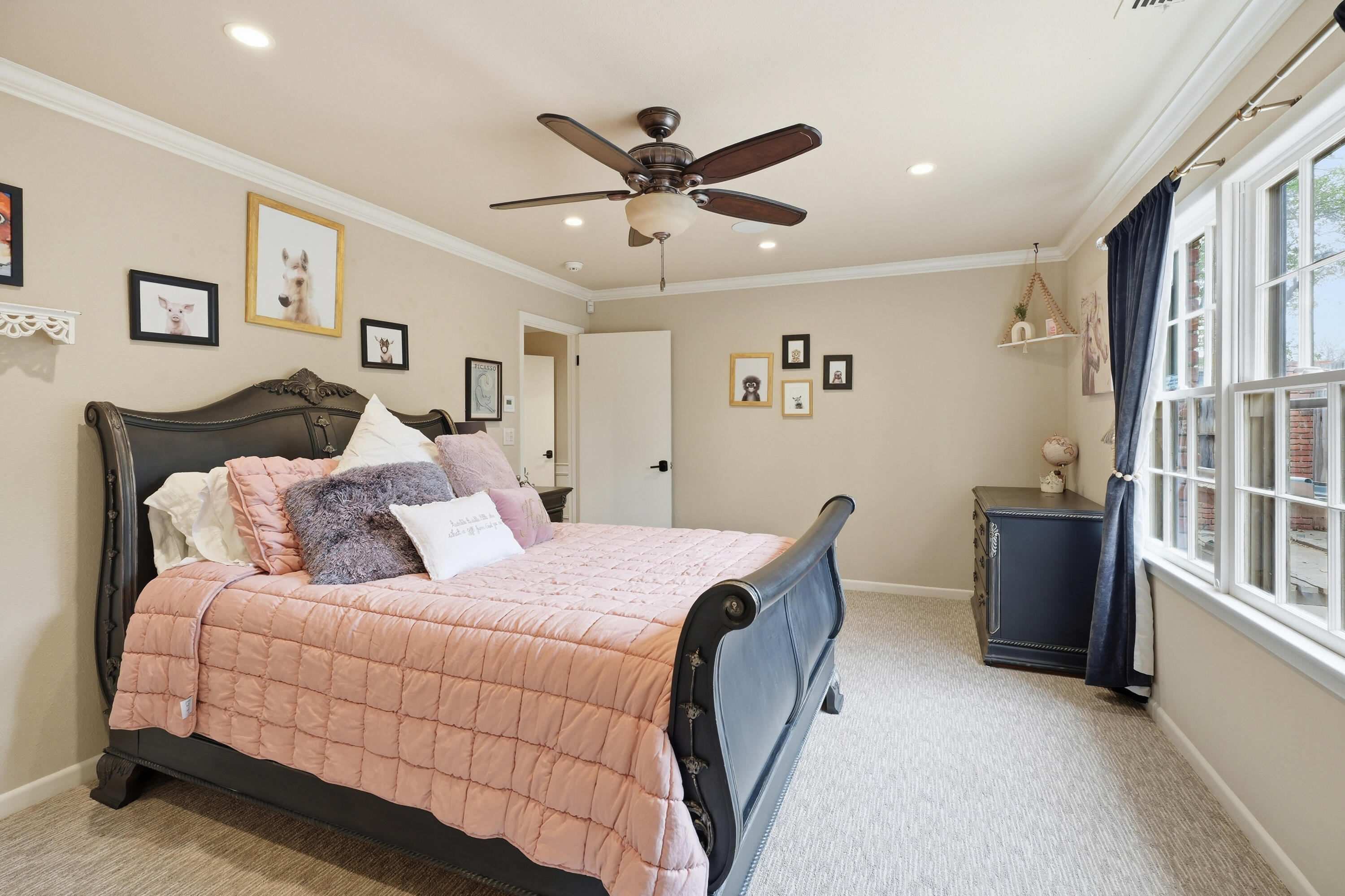4602 13th Street Lubbock, TX 79416 - Photo 37 of 54 a bed room with a bed and a chandelier