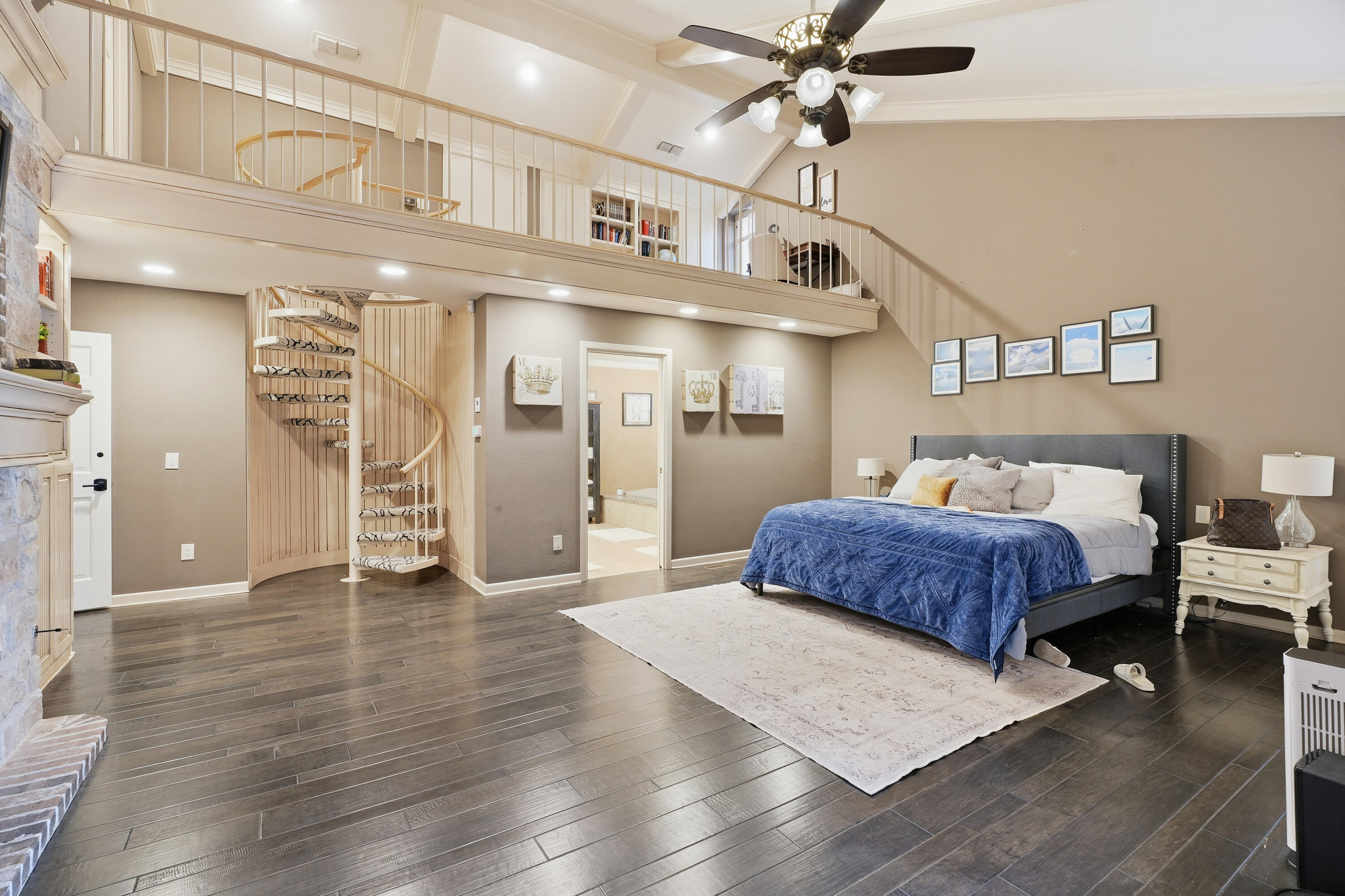 4602 13th Street Lubbock, TX 79416 - Photo 38 of 54 a spacious bedroom with a bed and a chandelier
