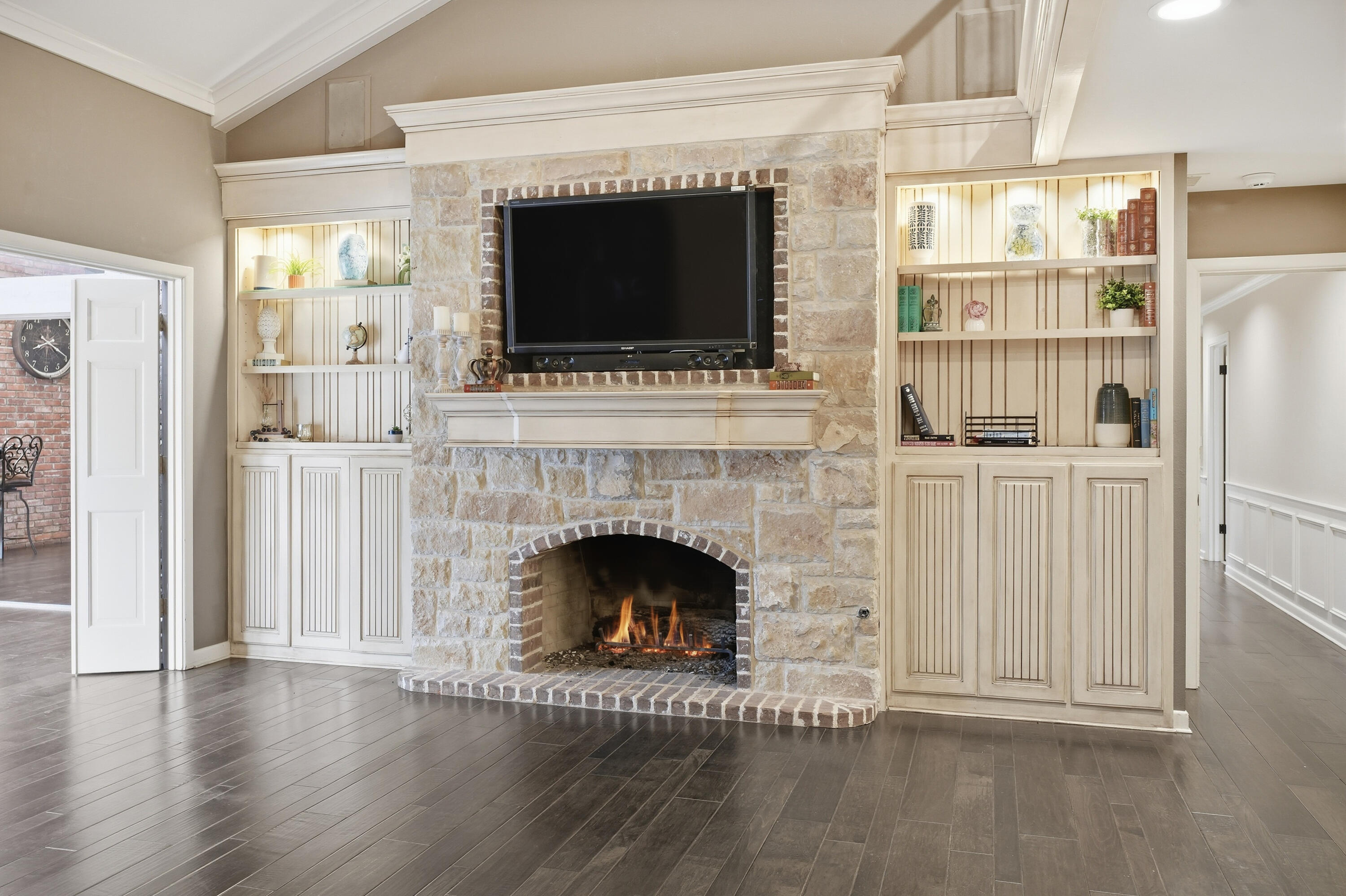 4602 13th Street Lubbock, TX 79416 - Photo 41 of 54 a living room with a fireplace and a flat screen tv