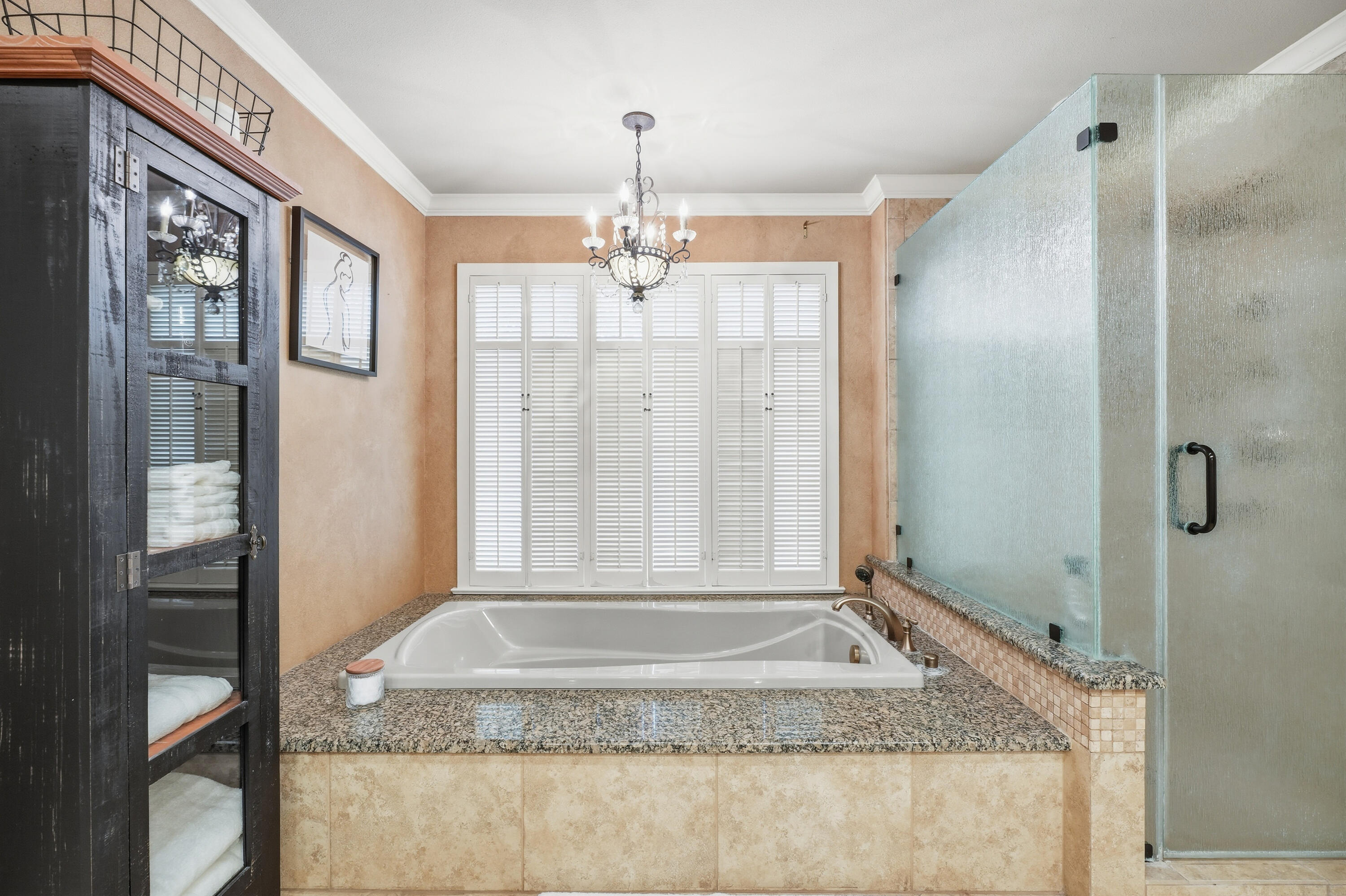 4602 13th Street Lubbock, TX 79416 - Photo 43 of 54 a bathroom with a granite countertop shower a mirror and a sink