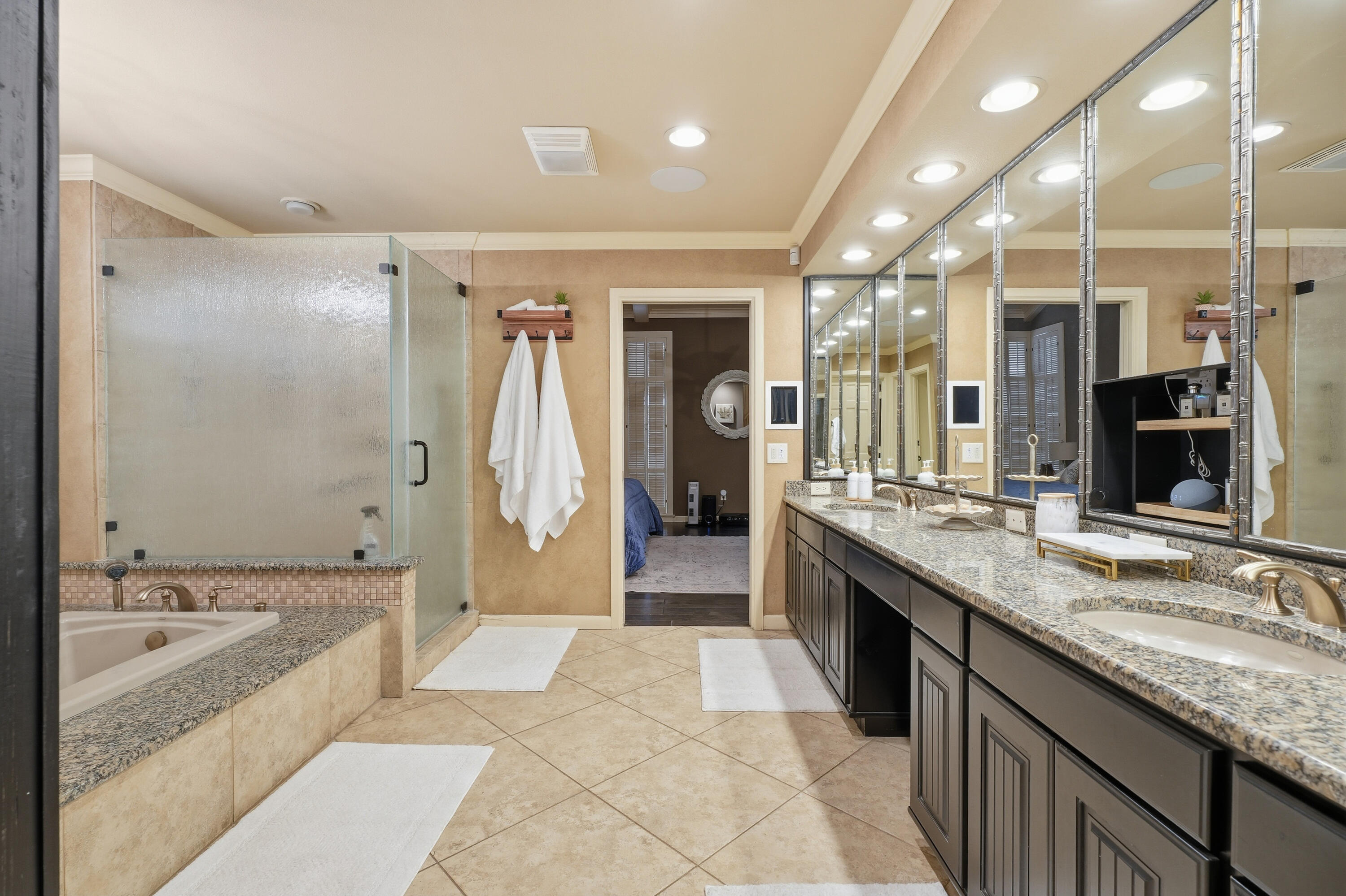 4602 13th Street Lubbock, TX 79416 - Photo 44 of 54 a large bathroom with a granite countertop tub sink shower and mirror