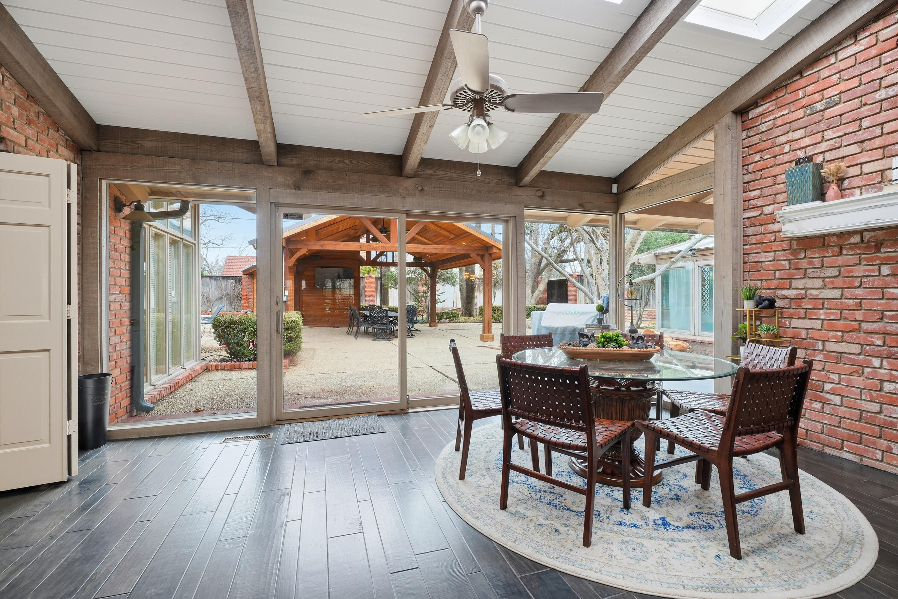 4602 13th Street Lubbock, TX 79416 - Photo 50 of 54 a dining room with wooden floor a glass table and chairs