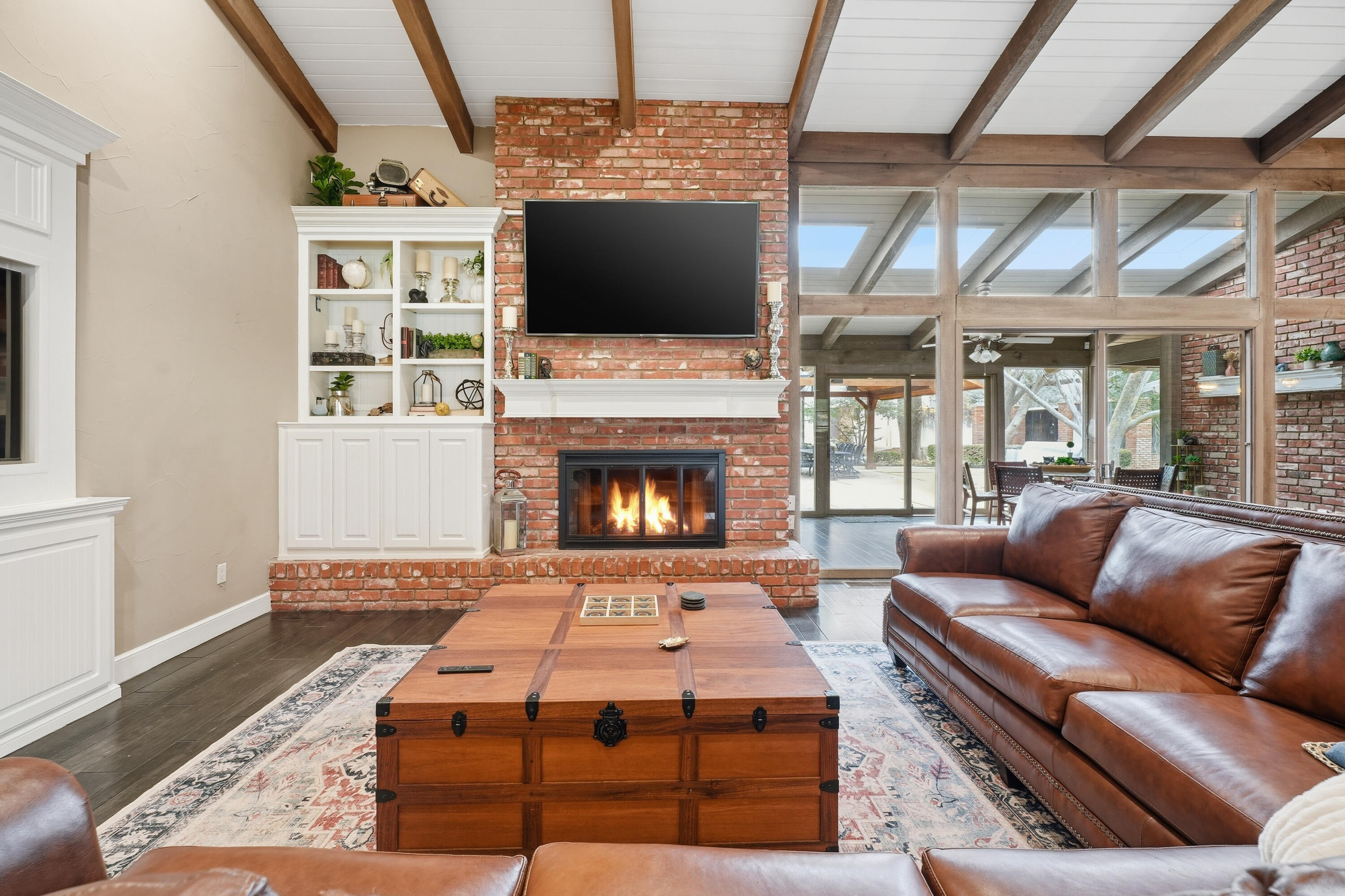 4602 13th Street Lubbock, TX 79416 - Photo 5 of 54 a living room with furniture a flat screen tv and a fireplace