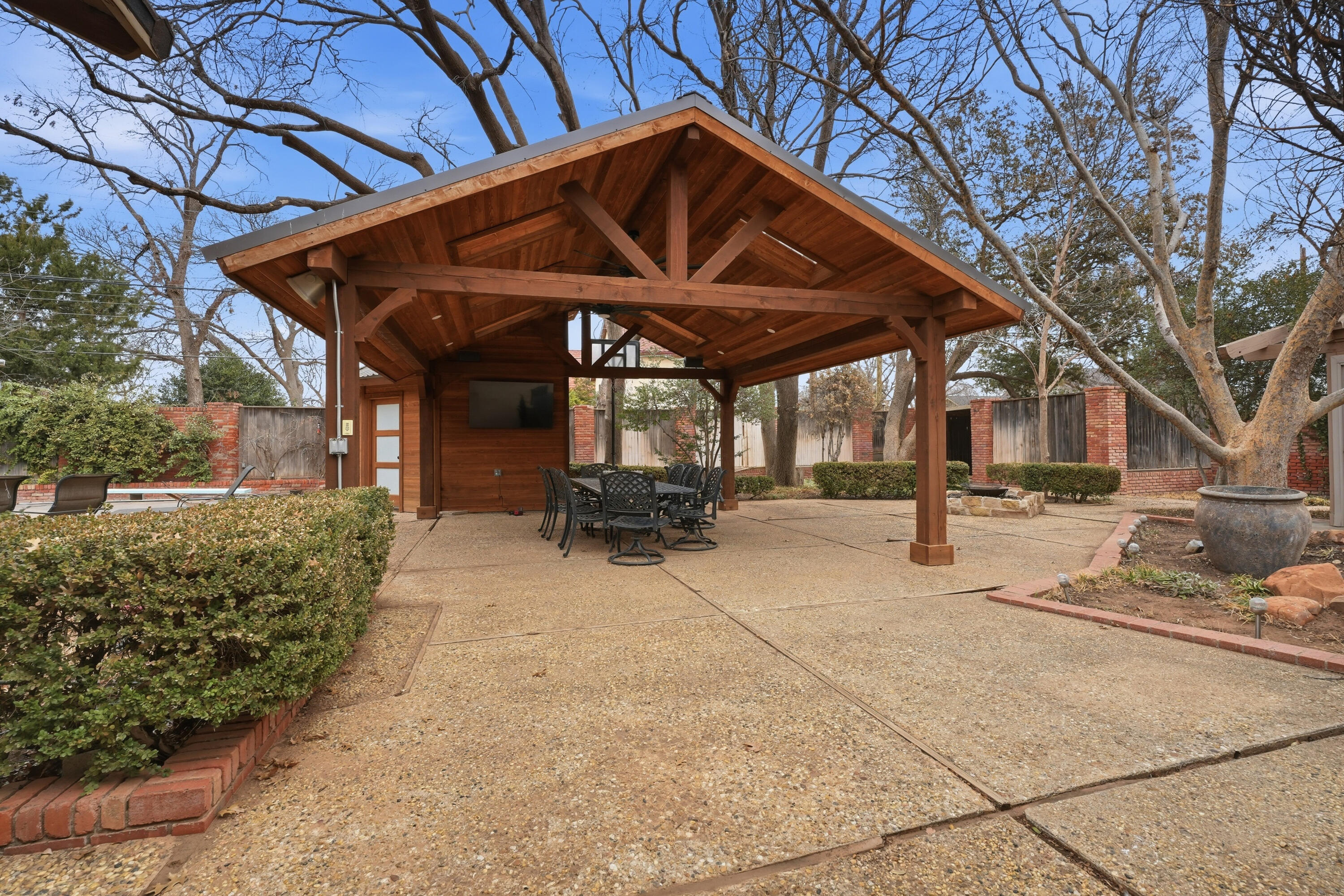 4602 13th Street Lubbock, TX 79416 - Photo 51 of 54 a view of a patio with a table and chairs under an umbrella