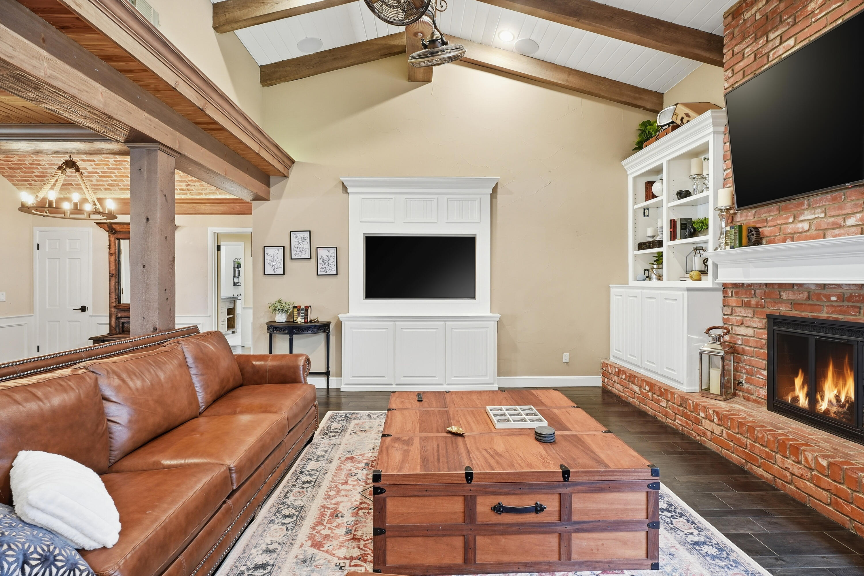 4602 13th Street Lubbock, TX 79416 - Photo 6 of 54 a living room with furniture a flat screen tv and a fireplace