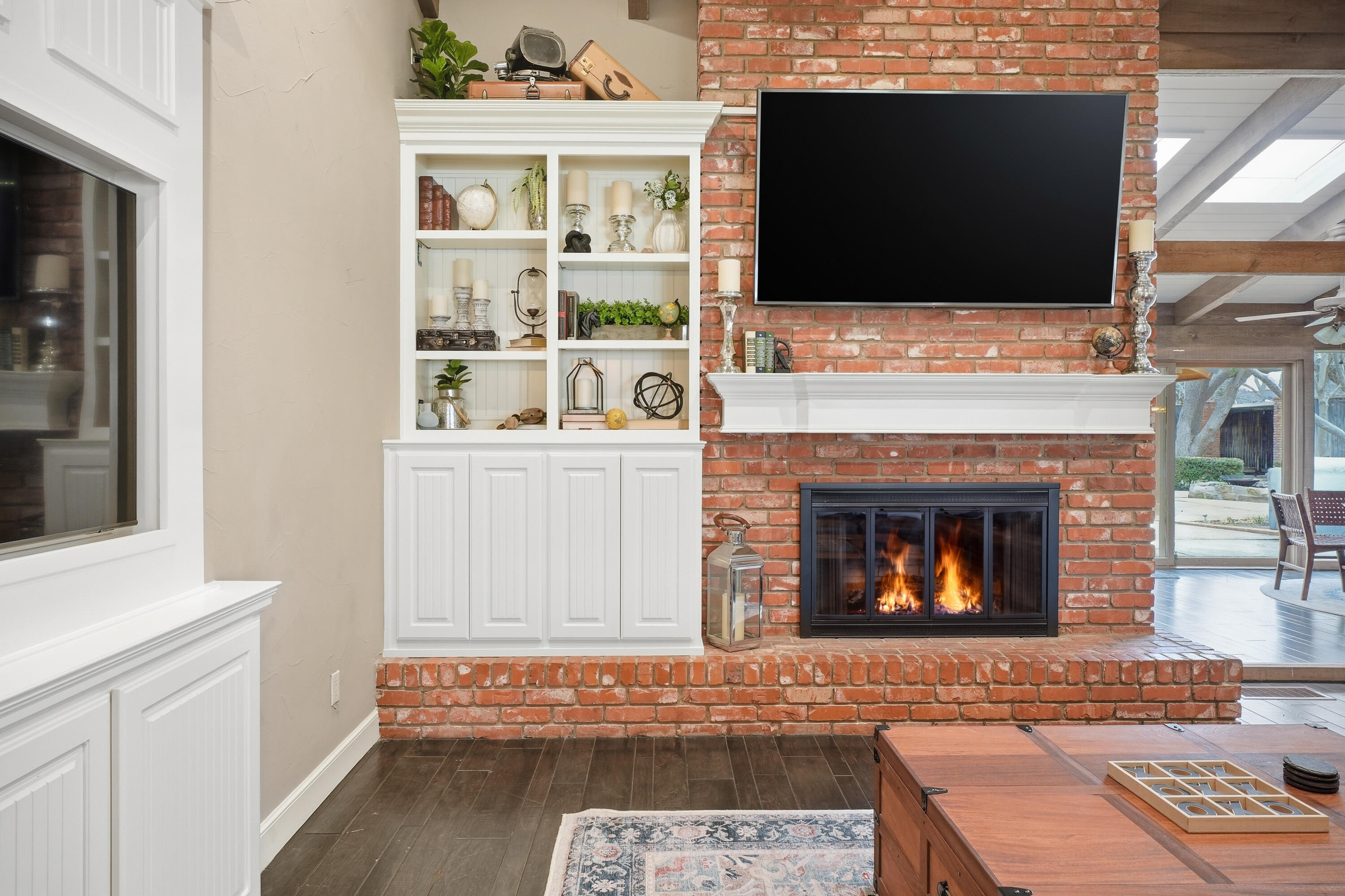 4602 13th Street Lubbock, TX 79416 - Photo 7 of 54 a living room with a fireplace and a flat screen tv