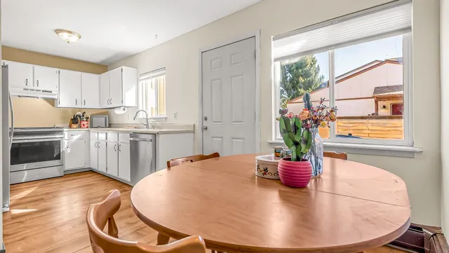 a kitchen with a table and chairs