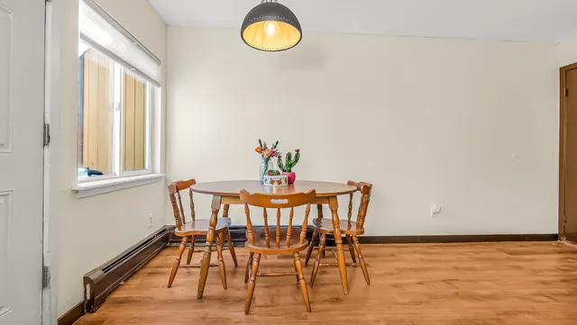 a view of a dining room with furniture and a window