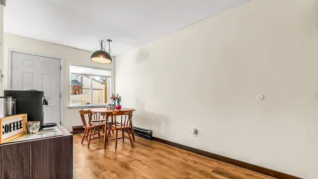 a view of a dining room with furniture and a window