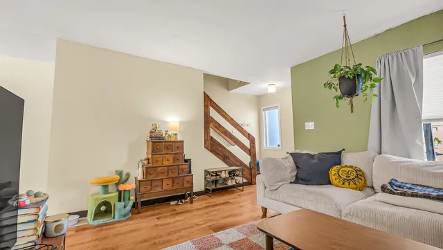 a living room with furniture and a stairs