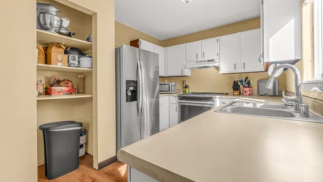 a kitchen with stainless steel appliances a refrigerator and a sink