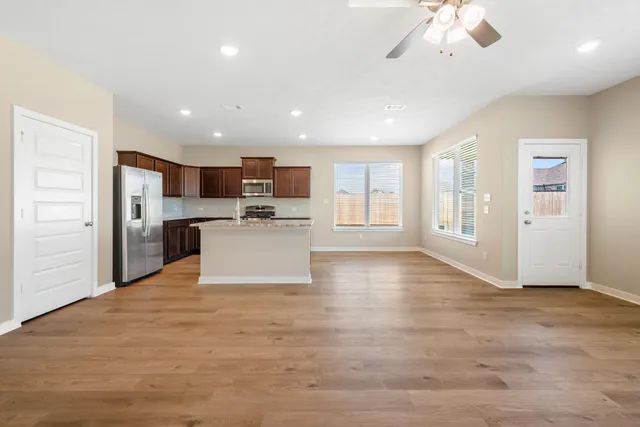 a view of kitchen with stove and cabinets