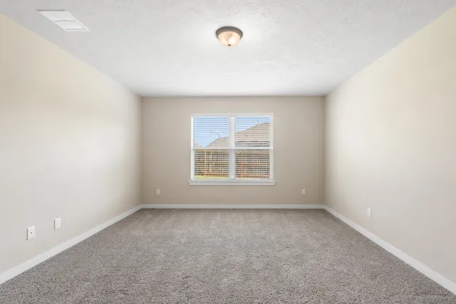 a view of an empty room and a window